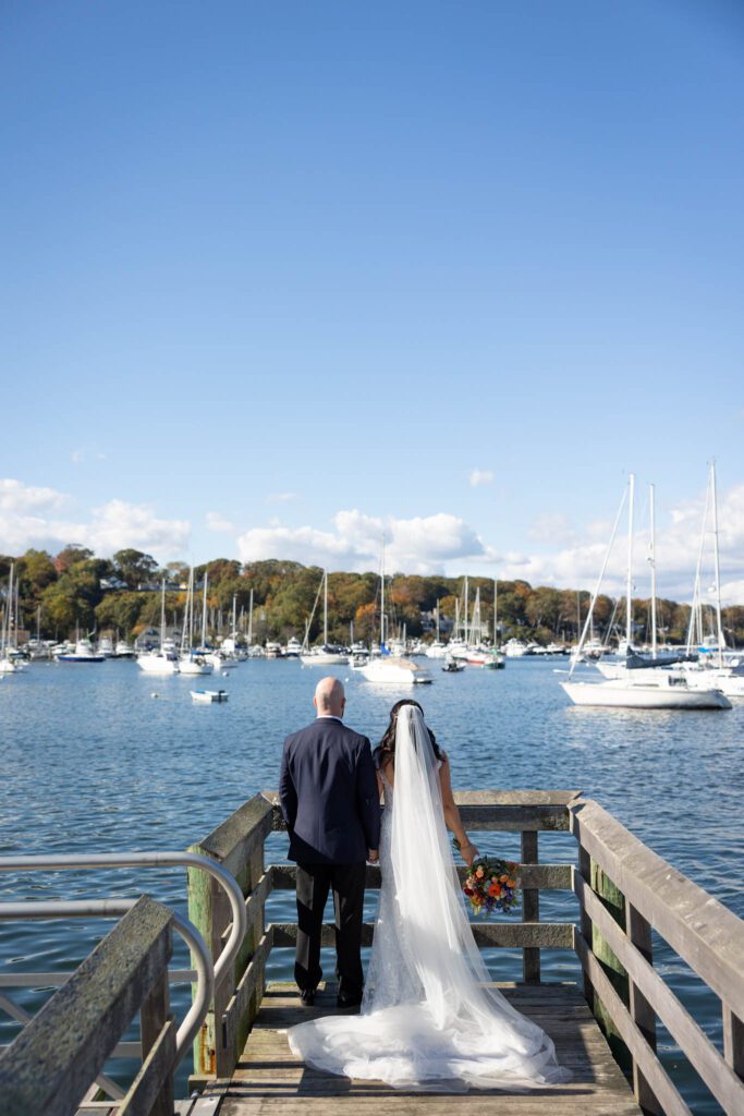 bride and groom on dock overlooking water Long Island waterfront wedding portrait
