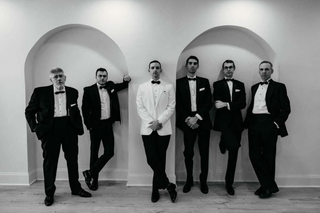 groom and groomsmen taking portraits morning of wedding in Long Island studio